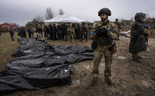 Soldiers stand guard as Ursula von der Leyen, European Commission President, visits a mass grave in Bucha, in the outskirts of Kyiv, Ukraine, Friday, April 8, 2022
