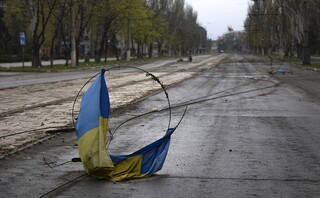 A Ukrainian national flag on a wire on the ground in an area controlled by Russian-backed separatist forces in Mariupol, Ukraine, Monday, April 18, 2022